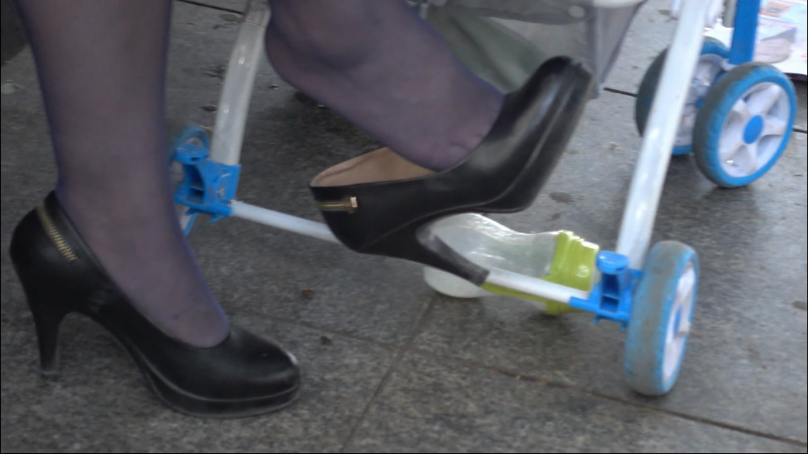 Women in public space looking information with dangling legs